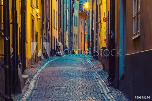 Bild på The narrow street of Gamla Stan - historic city old center of Stockholm at summer night with lanterns